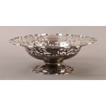 A GEORGE V SILVER PEDESTAL FRUIT BOWL, circular, broad pierced foliate border with C-scroll rim,