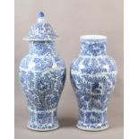 A PAIR OF 18TH CENTURY PAINTED CHINESE BLUE AND WHITE FLUTED BALUSTER VASES with lappet panelled