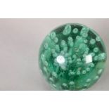 A 19TH CENTURY GREEN GLASS DUMP, internally decorated with a twist of bubbles, 13.5cm high