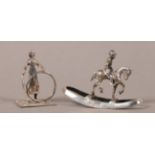 MINIATURES - A DUTCH SILVER ROCKING HORSE AND RIDER, 5cm long, marked; together with a silver