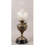 A LATE 19TH CENTURY BRASS OIL LAMP, the reservoir embossed with palmettes and scrolls, opaque etched