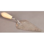 A VICTORIAN SILVER AND IVORY HANDLED CEREMONIAL TROWEL, the blade engraved with scrolling foliage,