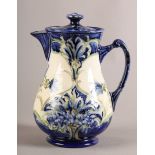 A MOORCROFT MACINTYRE FLORIAN WARE water jug and cover, the baluster body with foliate moulded