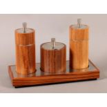 A LINLEY THREE PIECE CRUET IN AMERICAN WALNUT AND POLISHED STEEL, comprising cylindrical salt and
