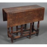 A LATE 17TH CENTURY OAK GATE LEG TABLE, the rectangular top with pair of conforming leaves,
