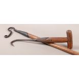 A 19TH CENTURY IRON BALE HOOK with T-bar wooden handle, 42cm long, together with a shepherd's