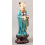 A 19TH CENTURY CHINESE STONEWARE FIGURE OF HAN ZHONGLI, one of the eight immortals, buff ground,