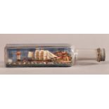 A VINTAGE SHIP IN A BOTTLE, the three masted sailing ship with smaller steam ship and lighthouse