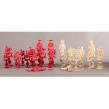 A CANTONESE IVORY AND RED STAINED IVORY CHESS SET, variously carved on 'puzzle ball' stems and
