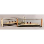 A PAIR OF PAINTED WOODEN MODELS OF THE RMS QUEEN MARY AND RMS MAURETANIA contained within glazed