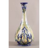 A MOORCROFT MACINTYRE FLORIAN WARE BALUSTER VASE with tall waisted neck and everted rim, slip