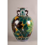A LARGE JAPANESE SATSUMA POTTERY VASE, baluster, boldly decorated with leaves in brown and greens on