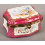 A 19TH CENTURY BERLIN PORCELAIN BOX, rectangular, the cover painted with flowers and distant
