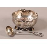 AN EDWARD VII SUGAR BOWL AND SIFTING SPOON, circular leaf form with scalloped wavy rim, on flowering