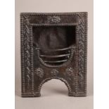 A LATE GEORGE III MINIATURE CAST IRON FIREPLACE with hob grate, 17cm high x 13cm wide, together with