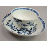 A Liverpool tea bowl and saucer, 18th century painted in underglaze blue with flowers and leafage