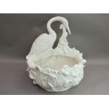 An Italian white pottery planter modelled as a floral and leaf moulded oval bowl with crane to the