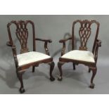 A pair of reproduction mahogany arm chairs in Chippendale style the interlaced pierced vasular