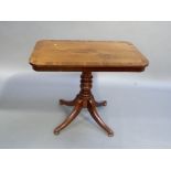 A post Regency mahogany dining table, the rounded rectangular top with figured centre and broad