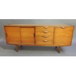 A six piece teak dining suite comprising extending dining table, sideboard and set of four chairs,