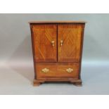 A reproduction mahogany television cabinet on George III style boxwood and ebony strung