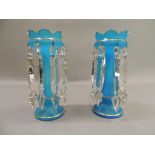 A pair of Victorian turquoise glass lustre stands with gilt detailed 'crowns' above baluster columns