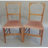 A pair of Edwardian mahogany bedroom chairs outlined throughout with boxwood stringing and barber