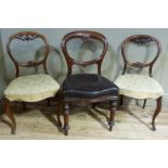 A pair of Victorian mahogany balloon back salon chairs with foliate moulding, upholstered seats