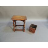 A reproduction oak joint stool the rectangular top with moulded lip above baluster turned legs