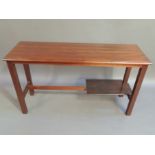A mahogany table, the rectangular top with moulded three quarter lip above square legs joined by