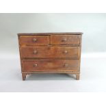 A George III mahogany miniature or apprentice chest the rectangular top with applied lip above two