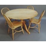 A circular kitchen table the circular sycamore top above baluster turned pillar and three out swept