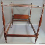 A reproduction mahogany four poster bed with urn finials, baluster turned posts, the headboard of