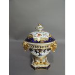 A Derby porcelain pot pourri vase, the guilloche pierced rim set with four grotesque masks above