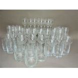 A suite of etched glassware comprising twelve champagne flutes, six brandy glasses, six short and
