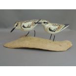 Frank Shields - A pair of carved wooden birds on free form trunk, the base signed, 38cm wide