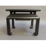 A reproduction ebonised wooden occasional table in Chinese style the top above a shallow frieze with