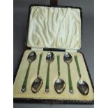 A set of six silver and enamel tea spoons the stems olive green enamel with white enamel triple
