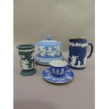 A Wedgwood blue jasper dip, cup and saucer detailed in relief with alternately applied trees and