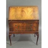 A reproduction mahogany bureau in George III style the figured fall-flap boxwood strung and with
