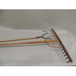 A vintage shepherds double crook with ash handle together with a wooden rake, double shepherds crook