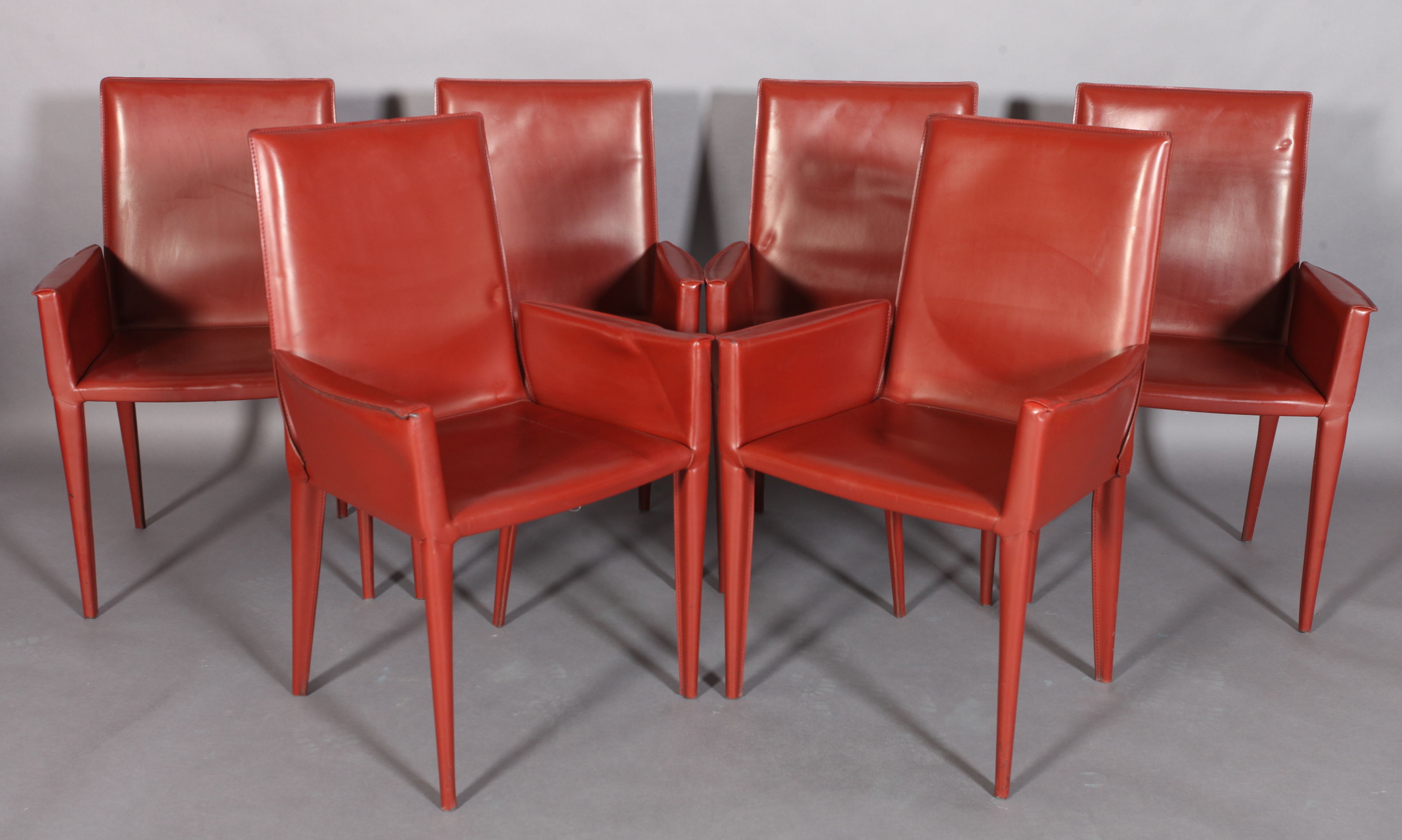 FRAG, ITALY, a set of six fox red leather high back dining chairs, on tapered legs