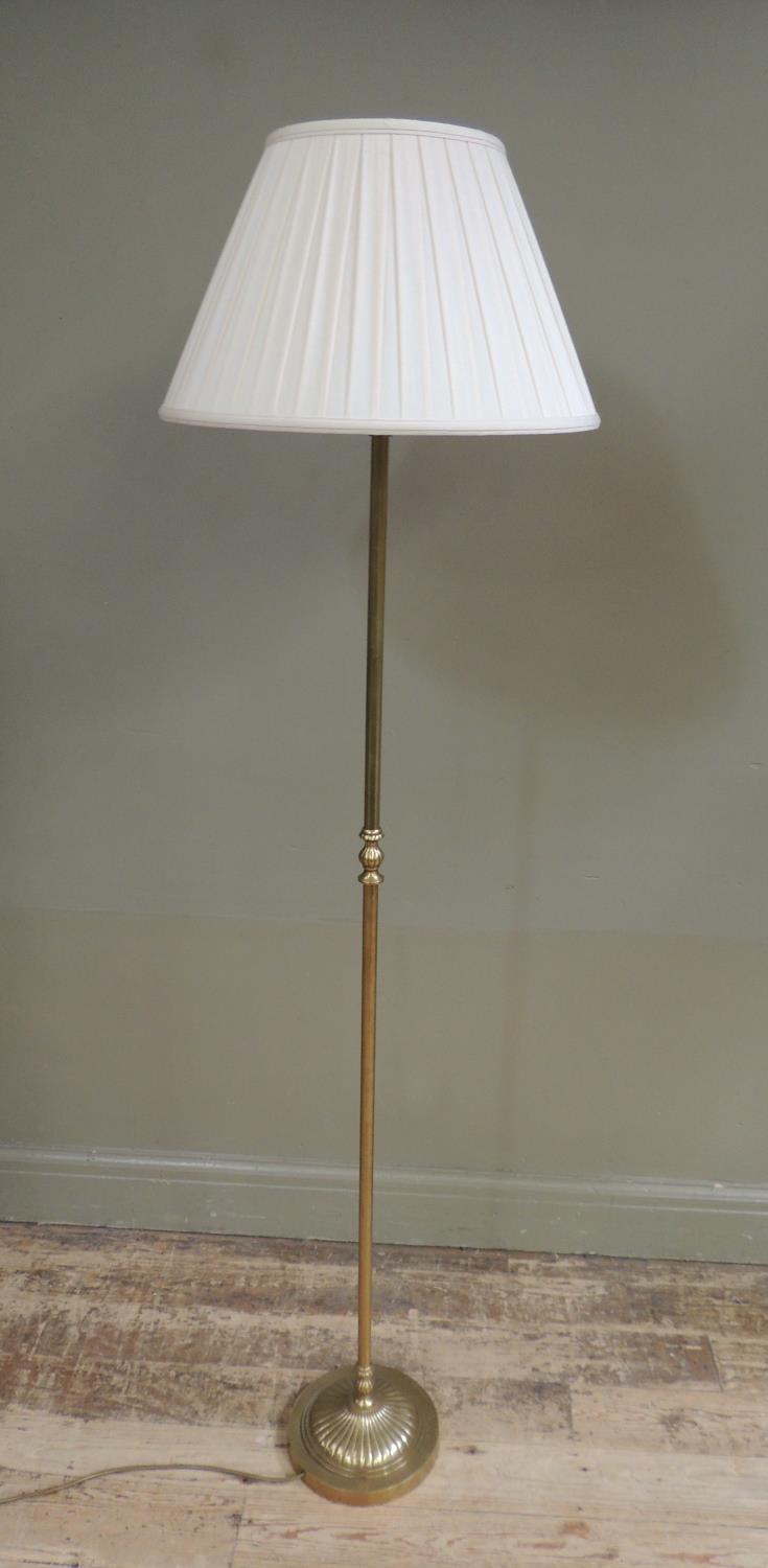 A brass standard lamp of column form on fluted circular base with pleated pale apricot cotton shade, - Image 2 of 2