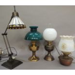 A modern angle poise lamp with coloured leaded glass shade, an Edwardian oil lamp, later converted
