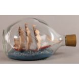 A vintage ship in a bottle, the three masted sailing vessel set within choppy waters, Haig dimple