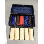 An early 20th century blue morocco leather box of gaming counters including ivorine, faux