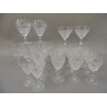 A part suite of heavily cut table glass comprising eight large wine goblets, three small wine