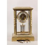 A late 19th Century continental brass cased four glass mantel clock set with turned and geometric
