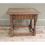 A reproduction oak joint stool, the rectangular top above fluted frieze, turned legs and carved