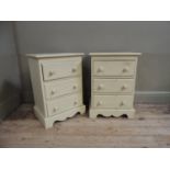 A pair of cream painted three drawer pine bedside chests with shaped apron and bracket feet, 46cm